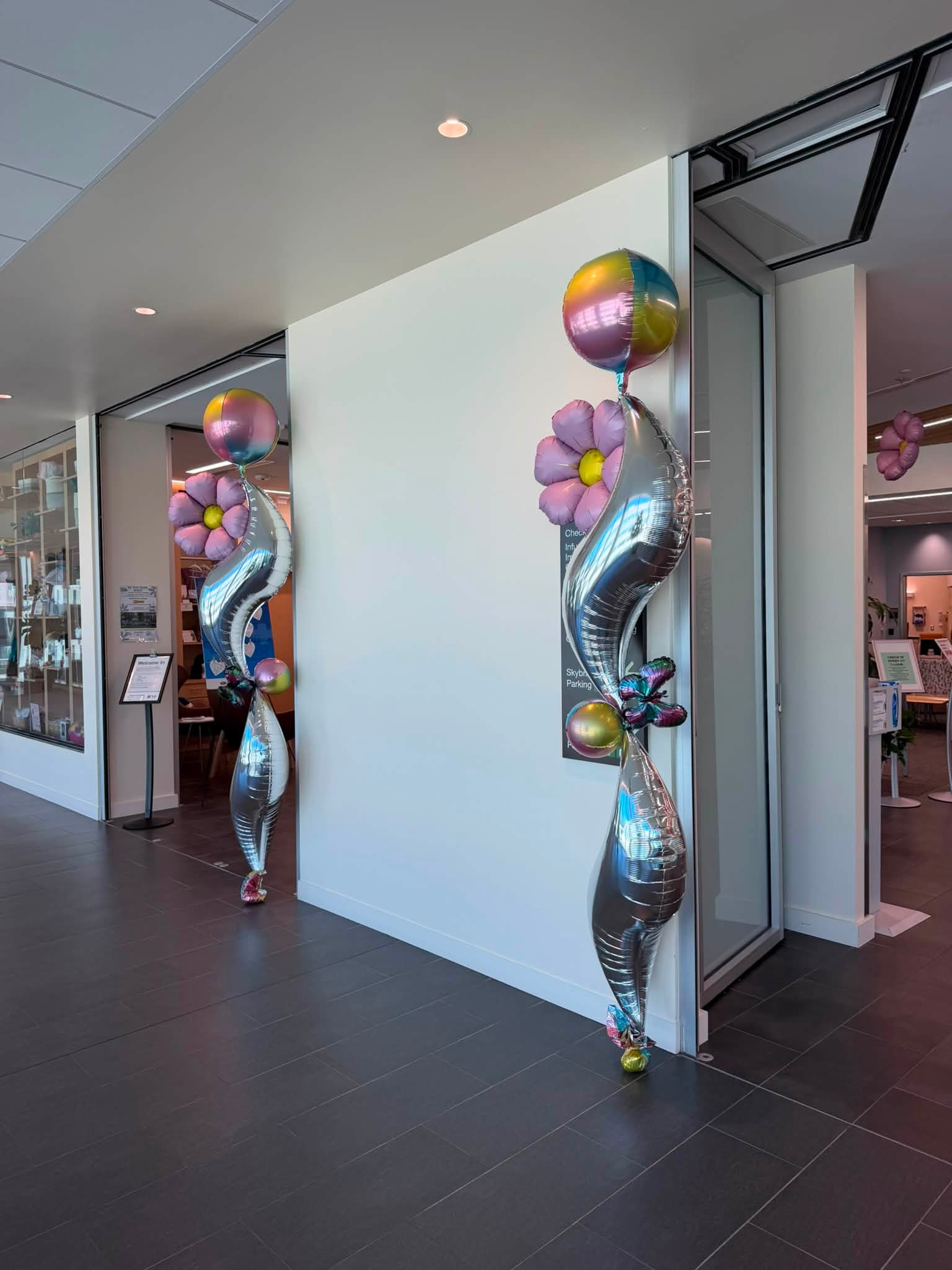 Elegant sculptural balloon columns decorating a modern entrance